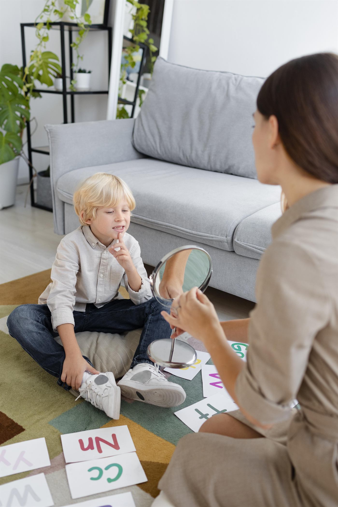 A therapist playing and learning with a toddler at home
