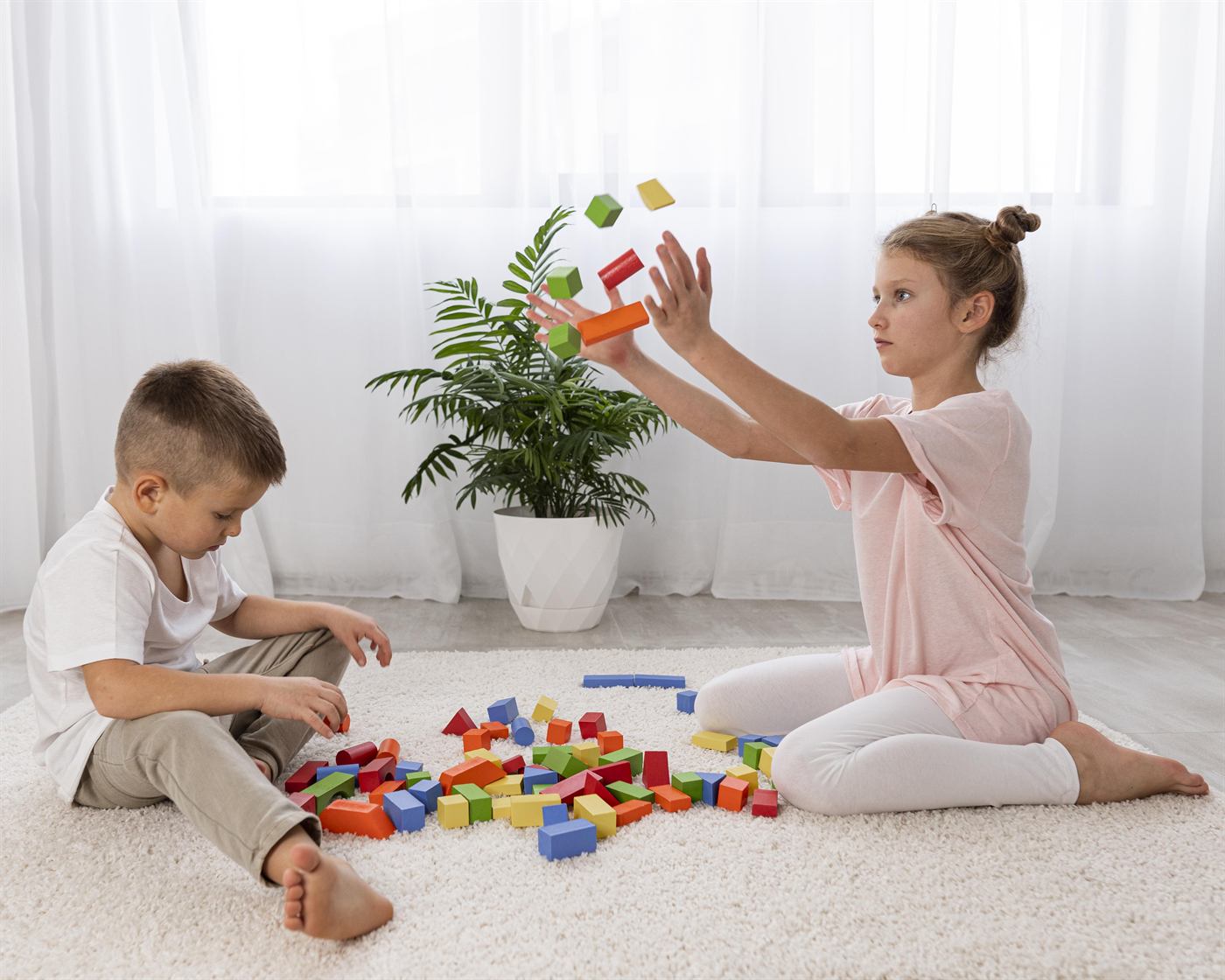 Two children playing with colorful building blocks
