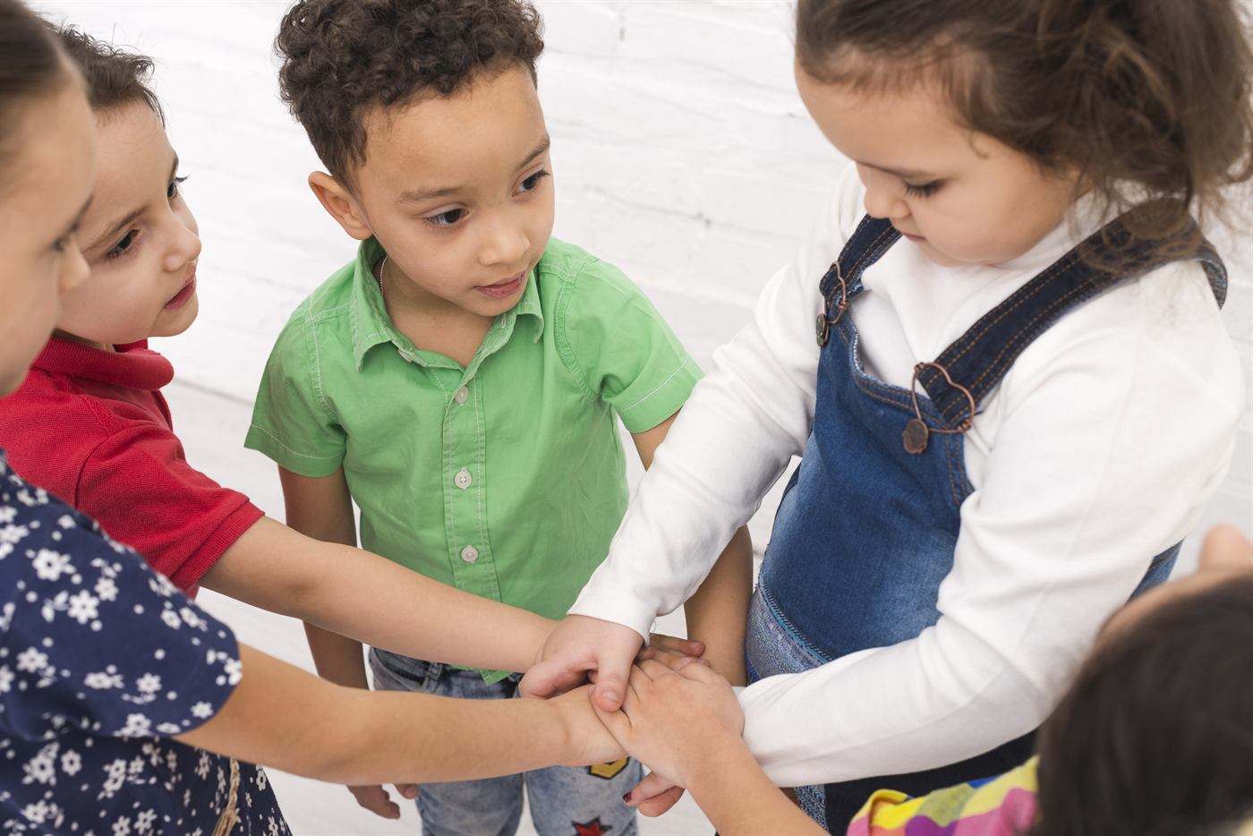 Young children holding hands in a circle
