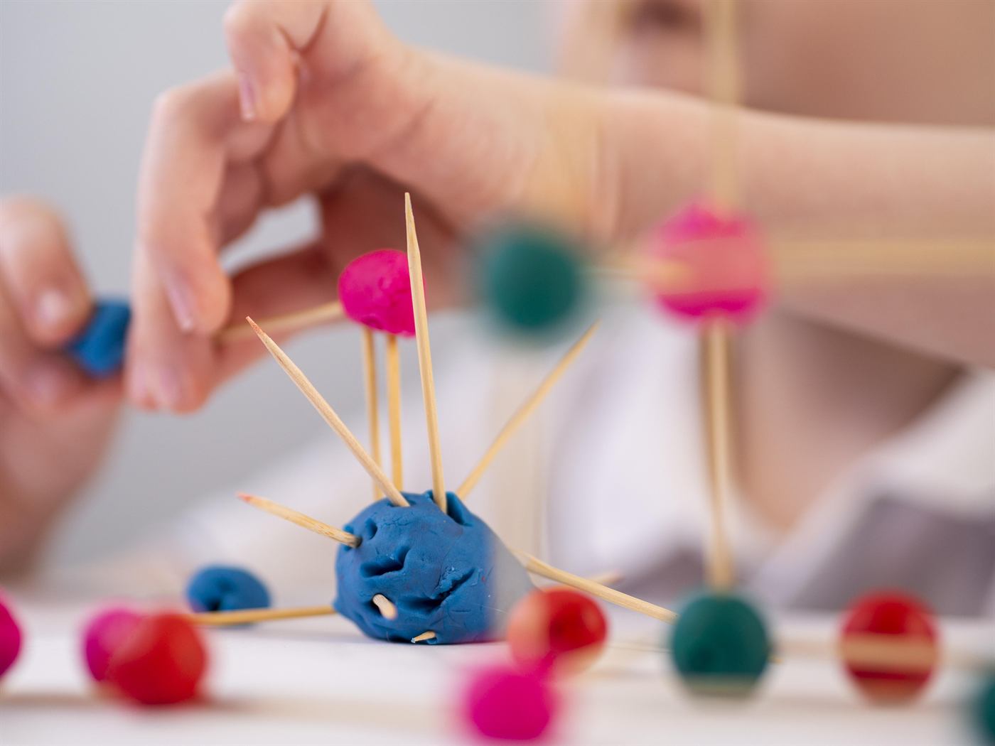 A child building with colorful pieces to practice fine motor skills