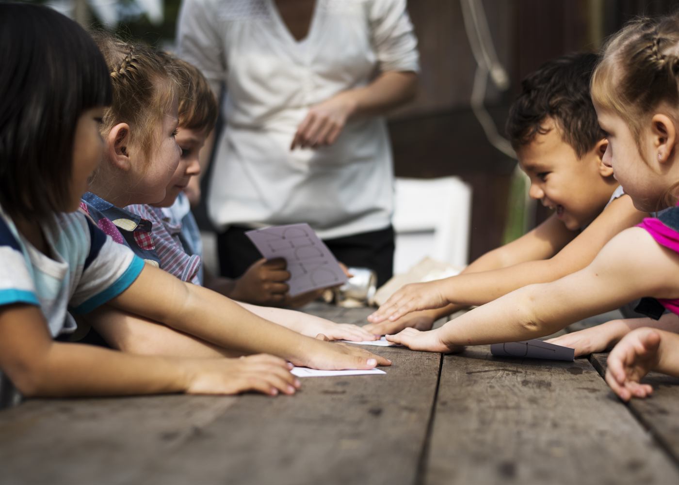 Children playing a word game together at a table