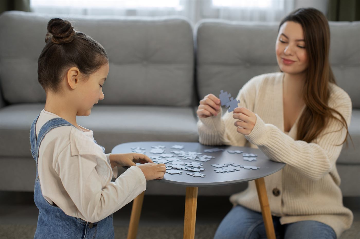 A mother and daughter playing a game together at home