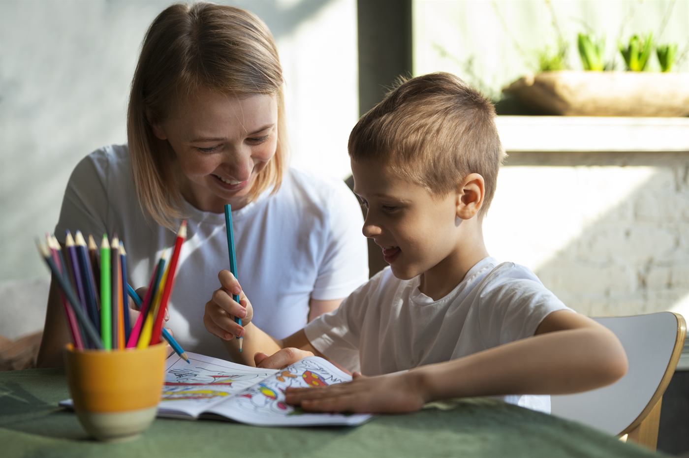 A mother helping her son with a learning activity at home